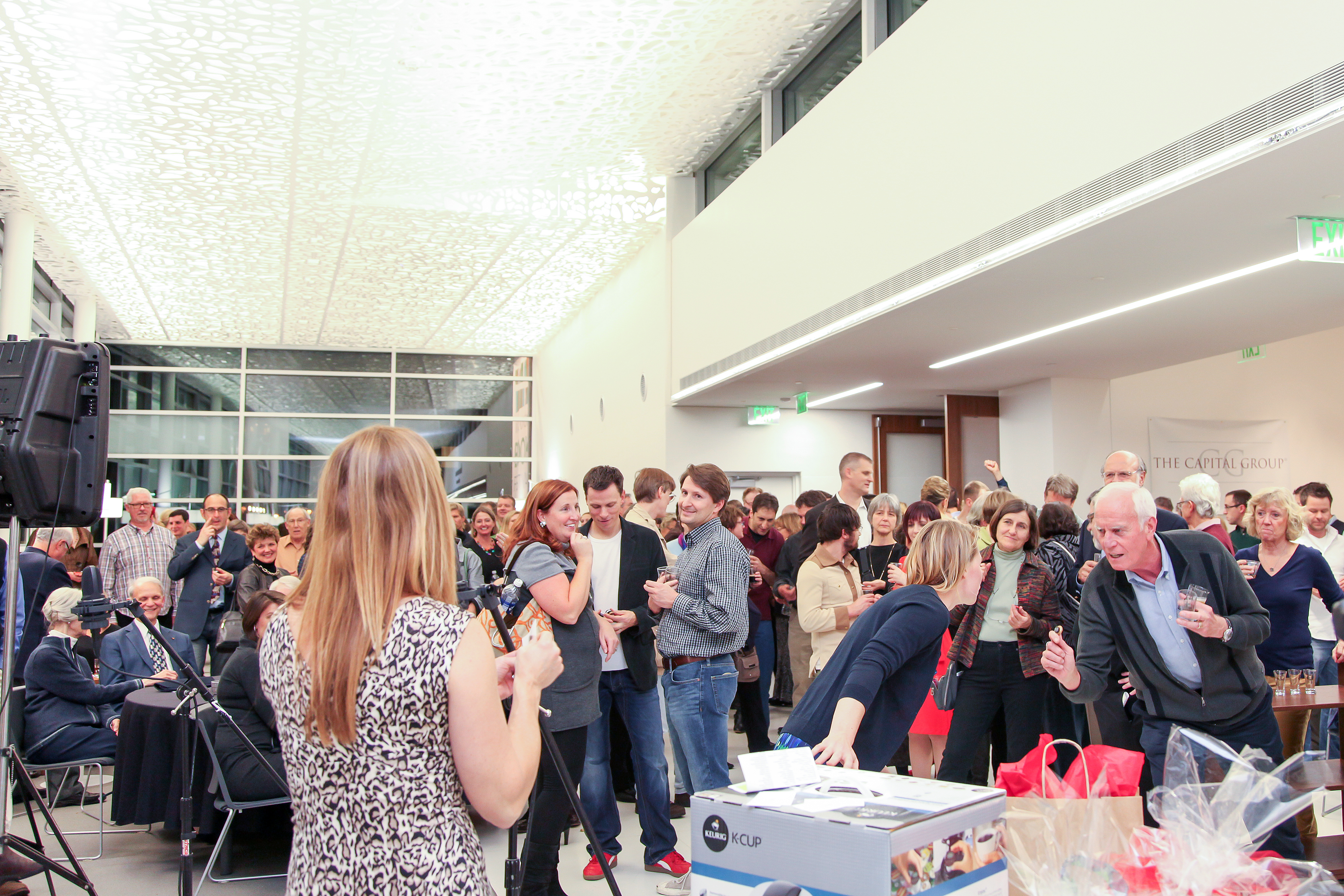 Large crowd of people mingling and drinking