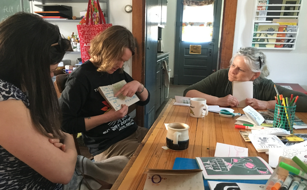 Whitehorse Middle School Librarian Emily Battenberg shows off her Zine at Communication Madison Teachers participating in maker education with the Bubbler