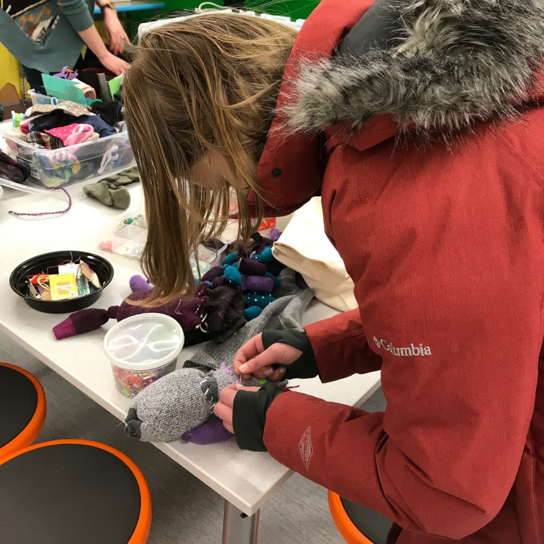 O'Keeffe 7th grader hard at work on her sock monster Student makes sock puppet