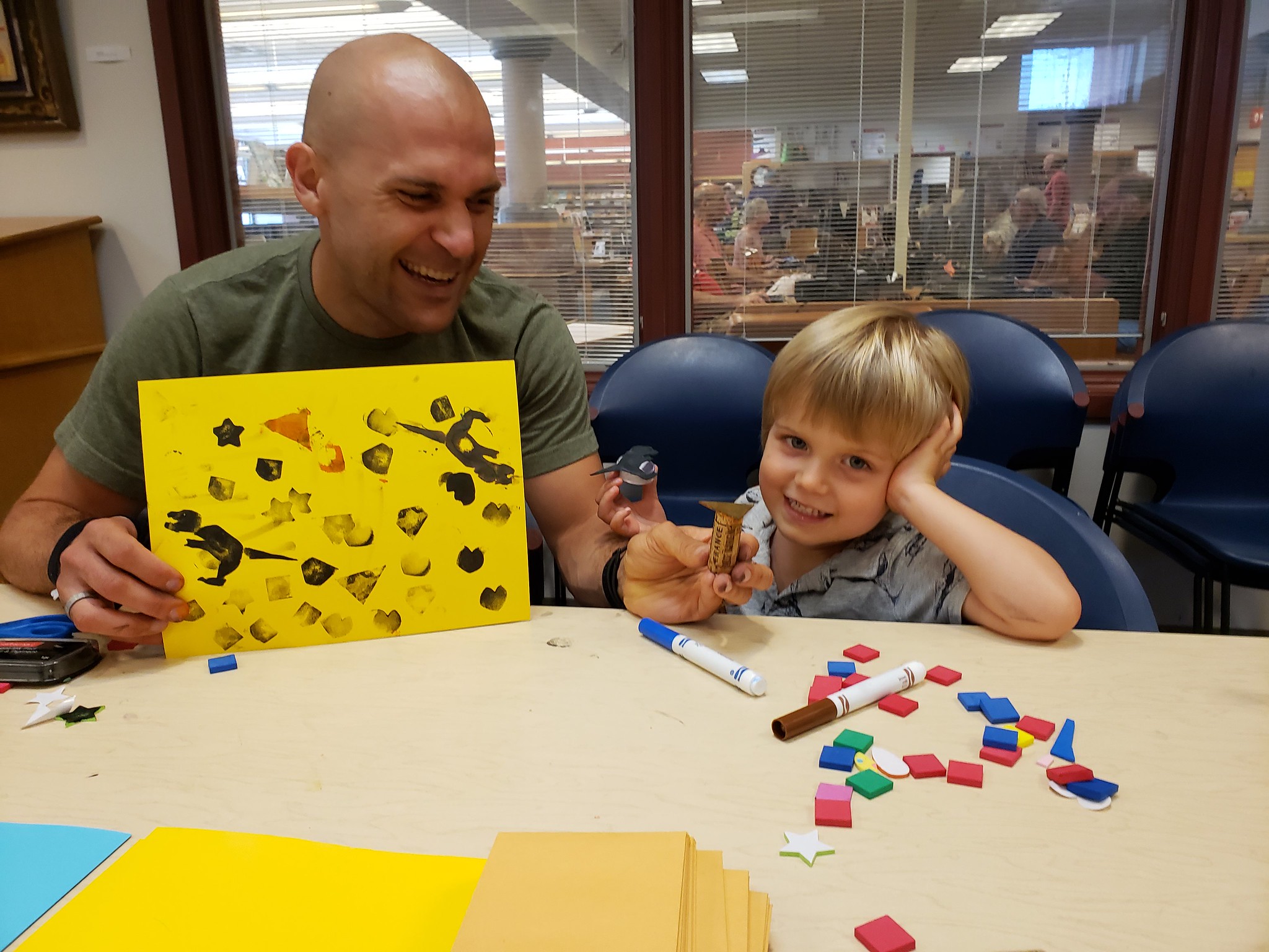 Parent and child show off their stamp-making creation Parent and child show off their stamp-making creation