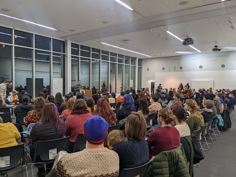 A large group of people seated and listening to a lecture