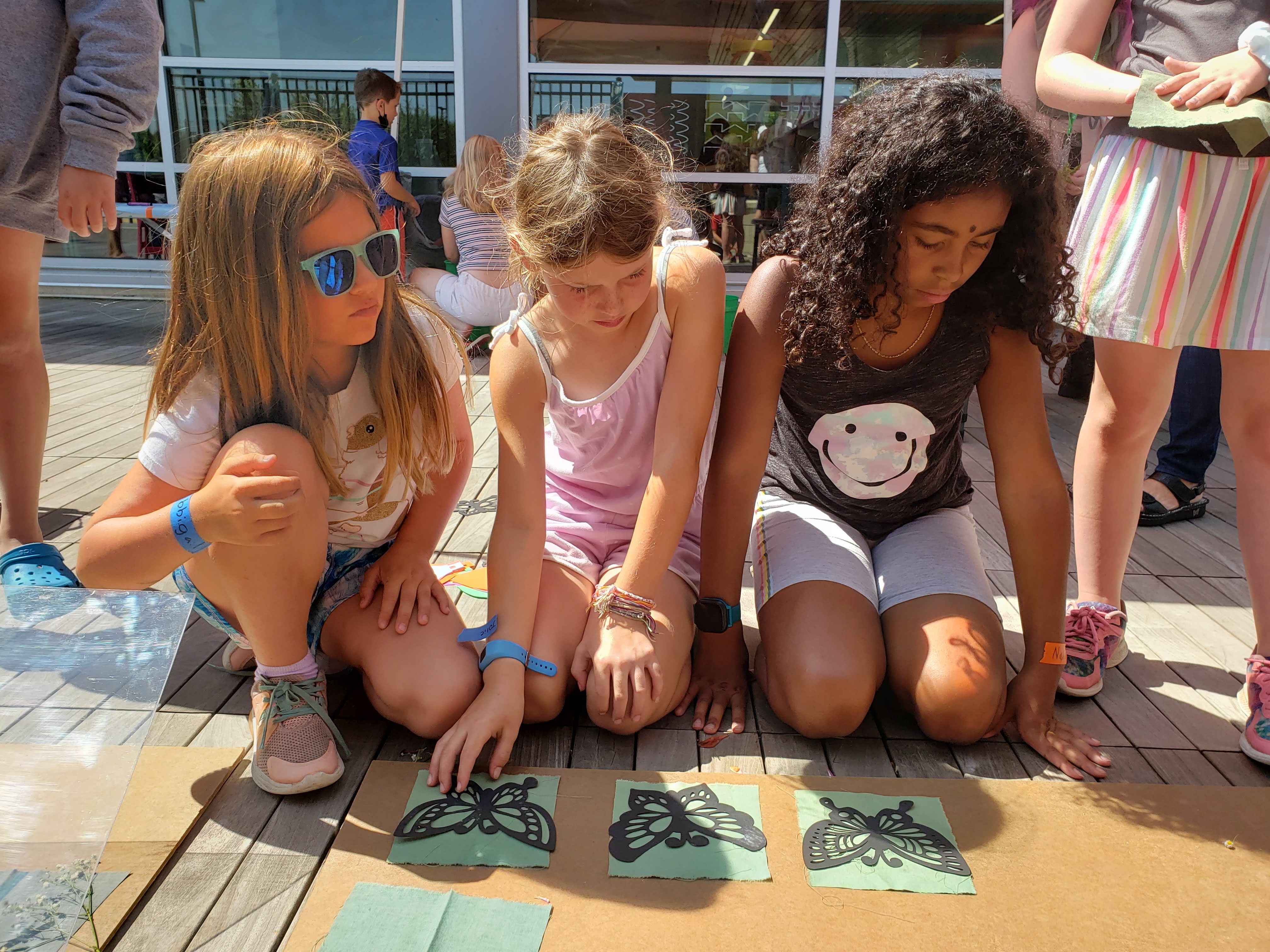 Exposing Sun Print at Pinney Library artists wait for their sun prints to be exposed