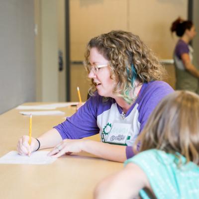 Amanda Farrar works with a chilld during Whoopensocker