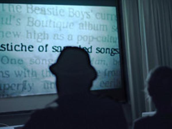 audience members in silhouette watching a film