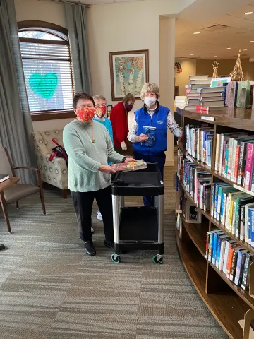 canva-photo-editor (19).png Oak Village Prairie Ridge resident volunteers stock their book nook
