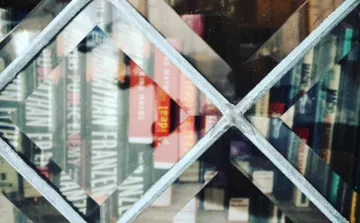 Little Free Library CIO Books behind a glass door of a Little Free Library