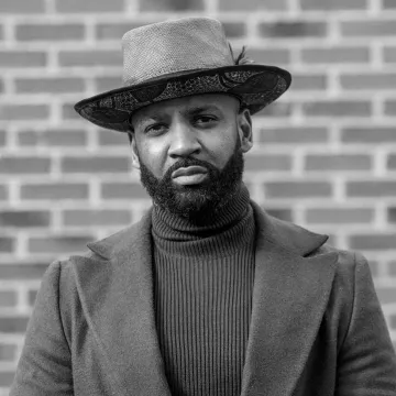A black-and-white professional photo of Derrick Harriell. A black-and-white professional photo of Derrick Harriell.