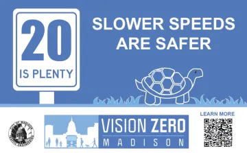 Blue and white sign with "Slower Speeds Are Safer" and an image of a turtle