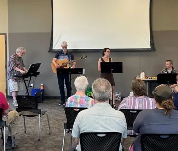 A musical group of four, performing in the Sequoya community room
