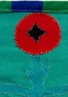 A small flower embroidered onto clothing A small flower embroidered onto clothing